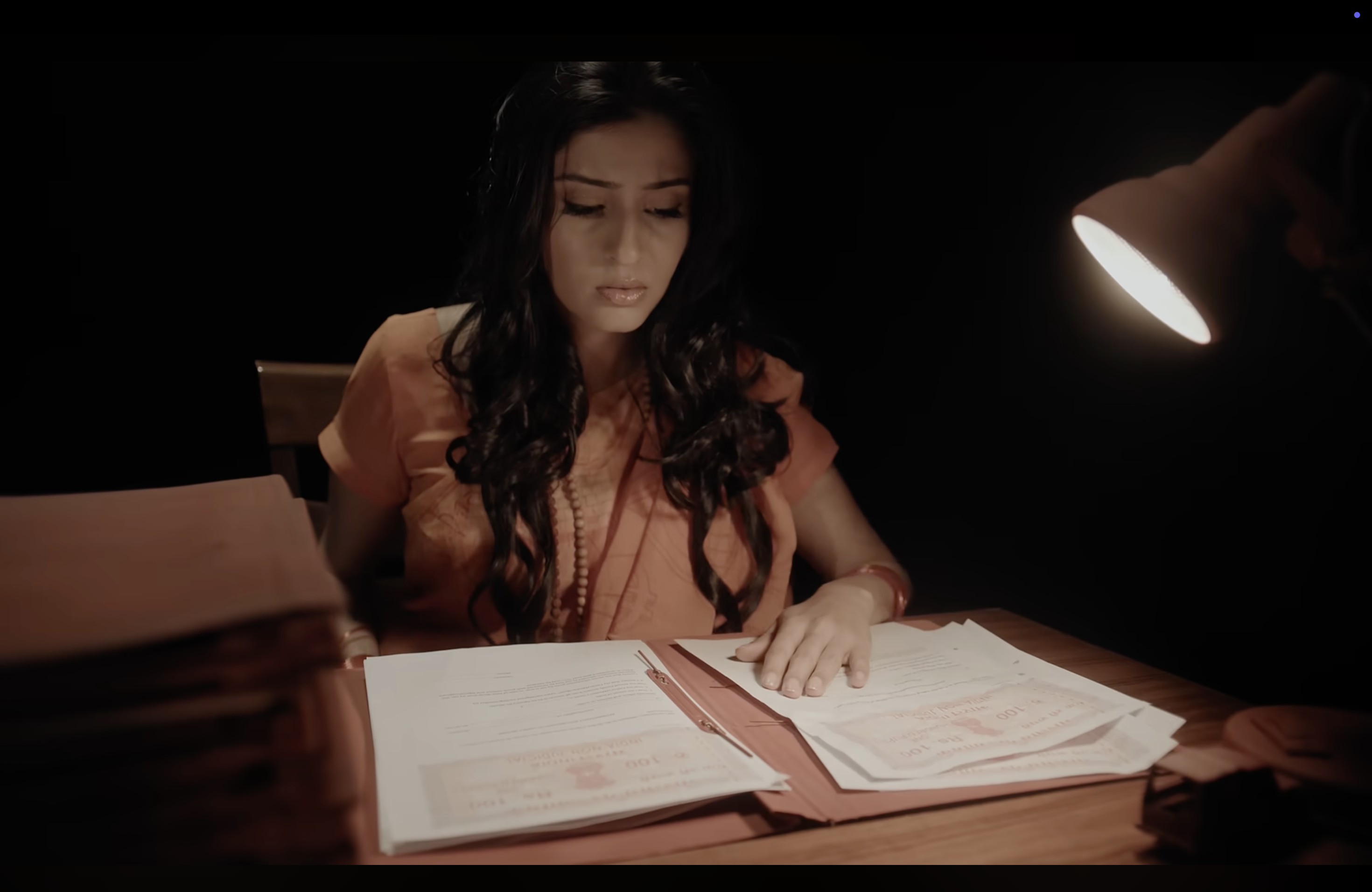 Kaahe Jaage Mohan: A woman seated at a desk
