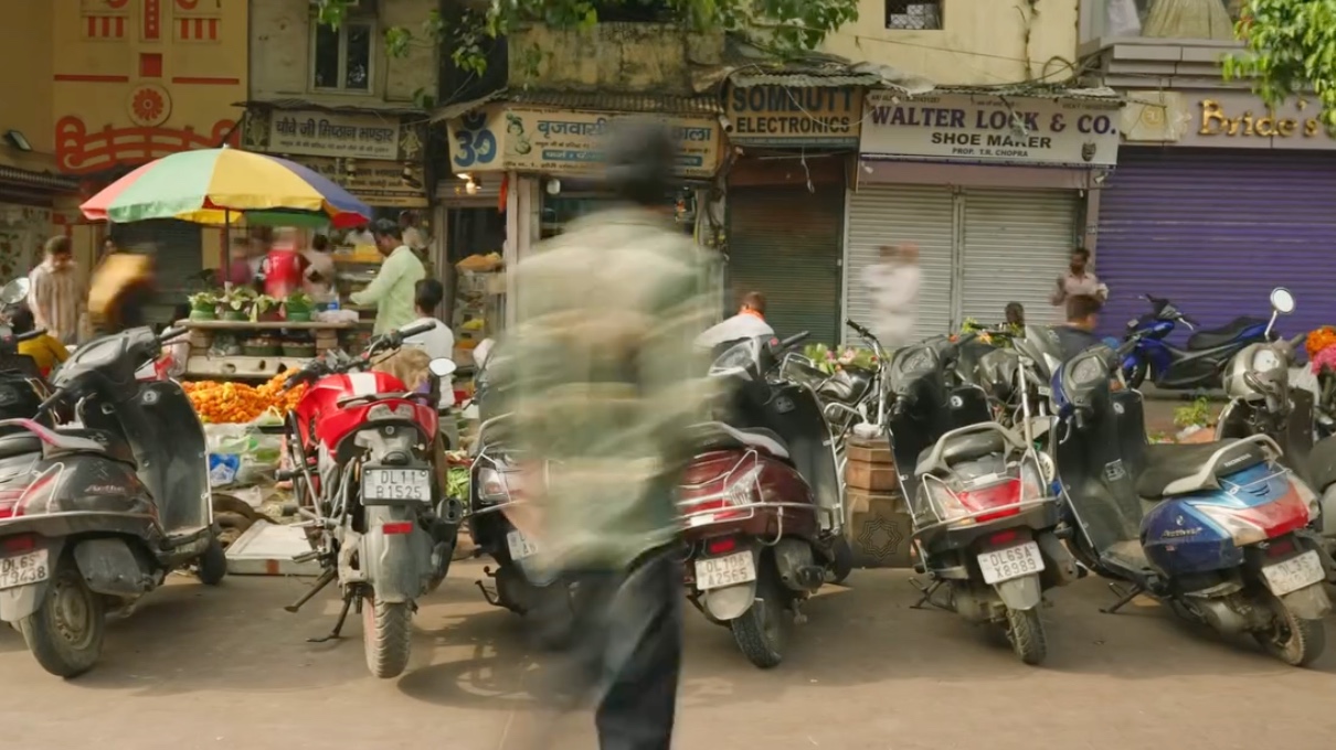 The Locked Doors of Delhi - 6: A busy street with scooters and market stalls