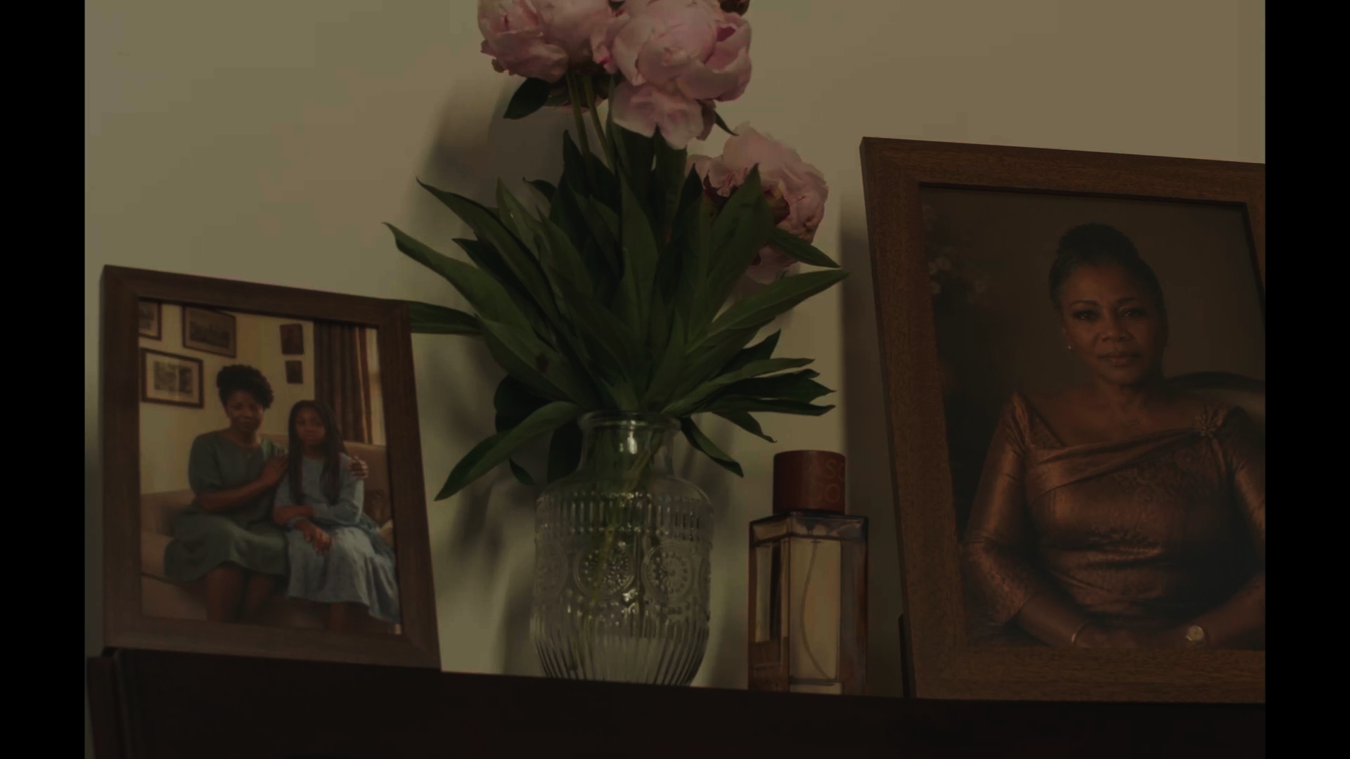 Unbecoming / Serwaa: Flowers and framed photographs