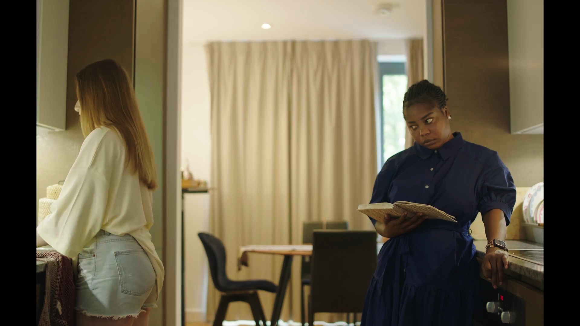 Unbecoming / Serwaa: Two people at a dining table