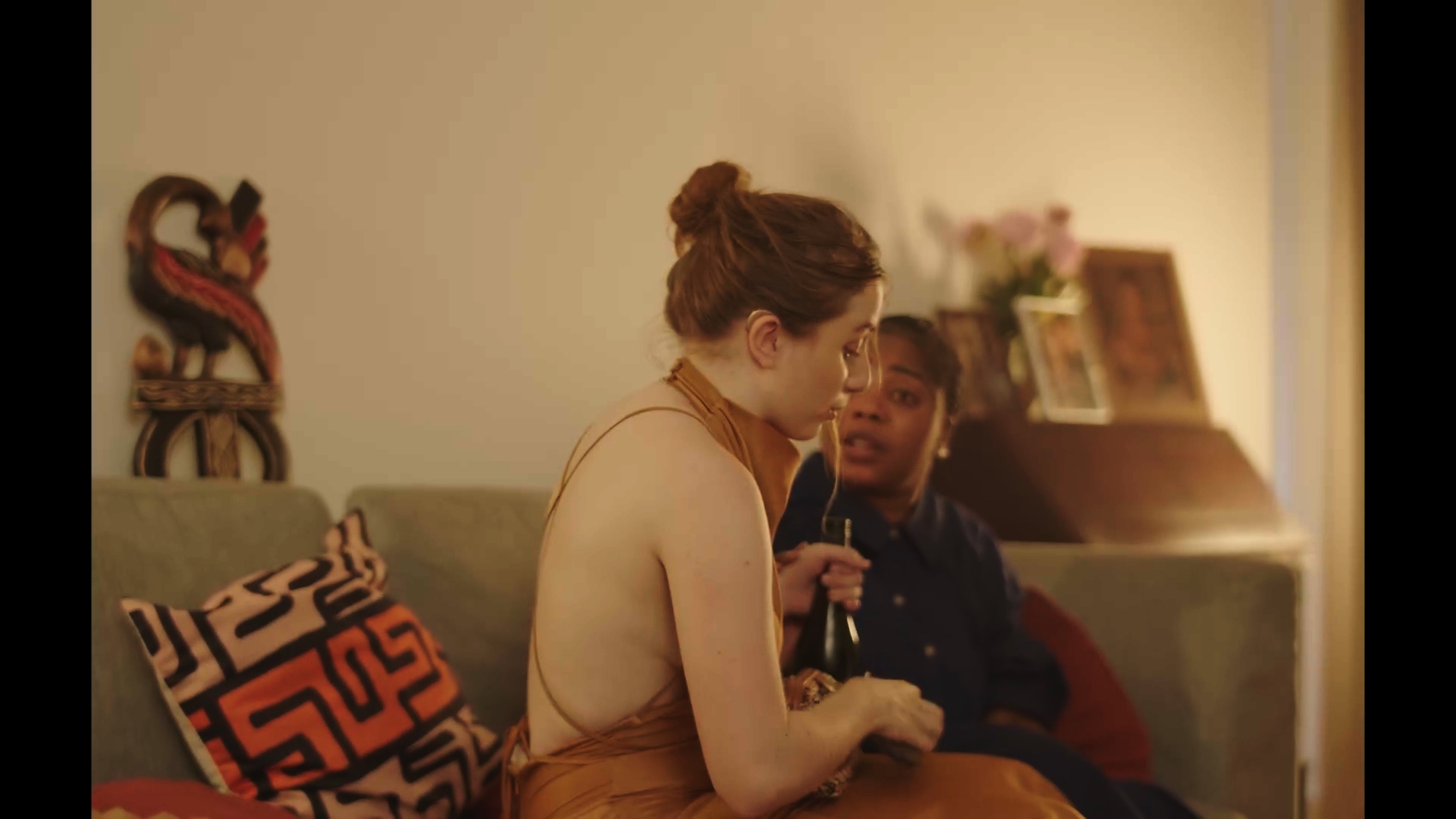 Unbecoming / Serwaa: Two people together on a sofa