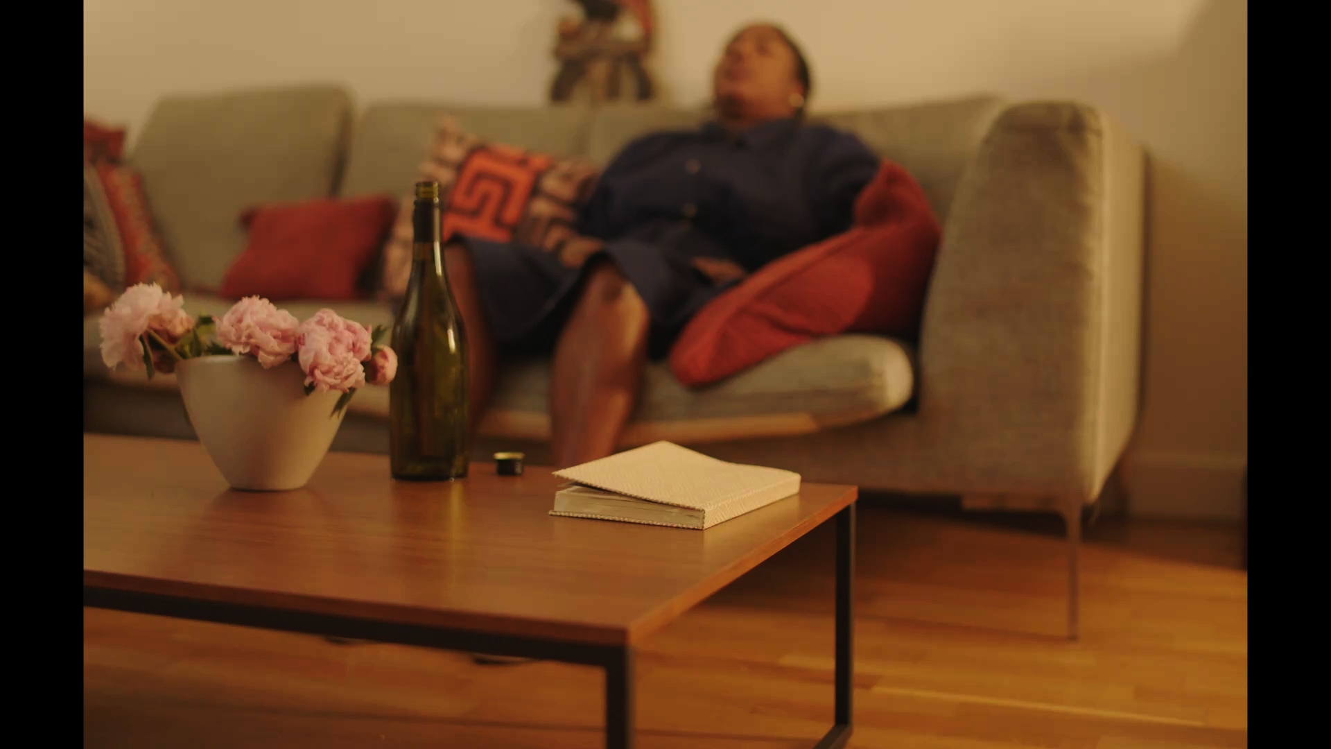 Unbecoming / Serwaa: A man relaxing on a sofa