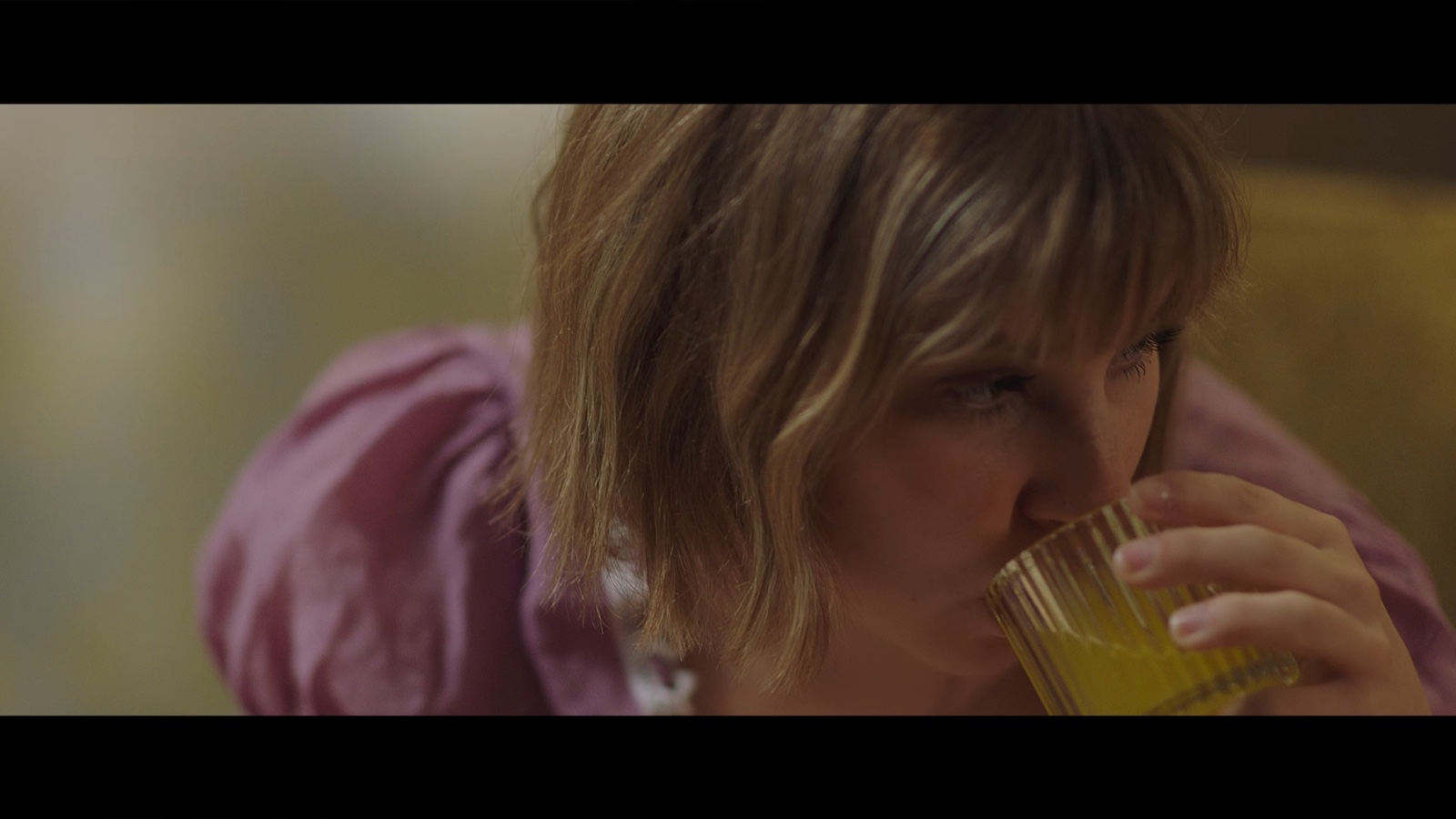 Between Worlds: A woman drinking from a glass