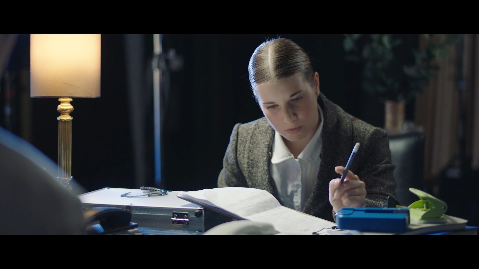 Between Worlds: A woman speaking across a desk