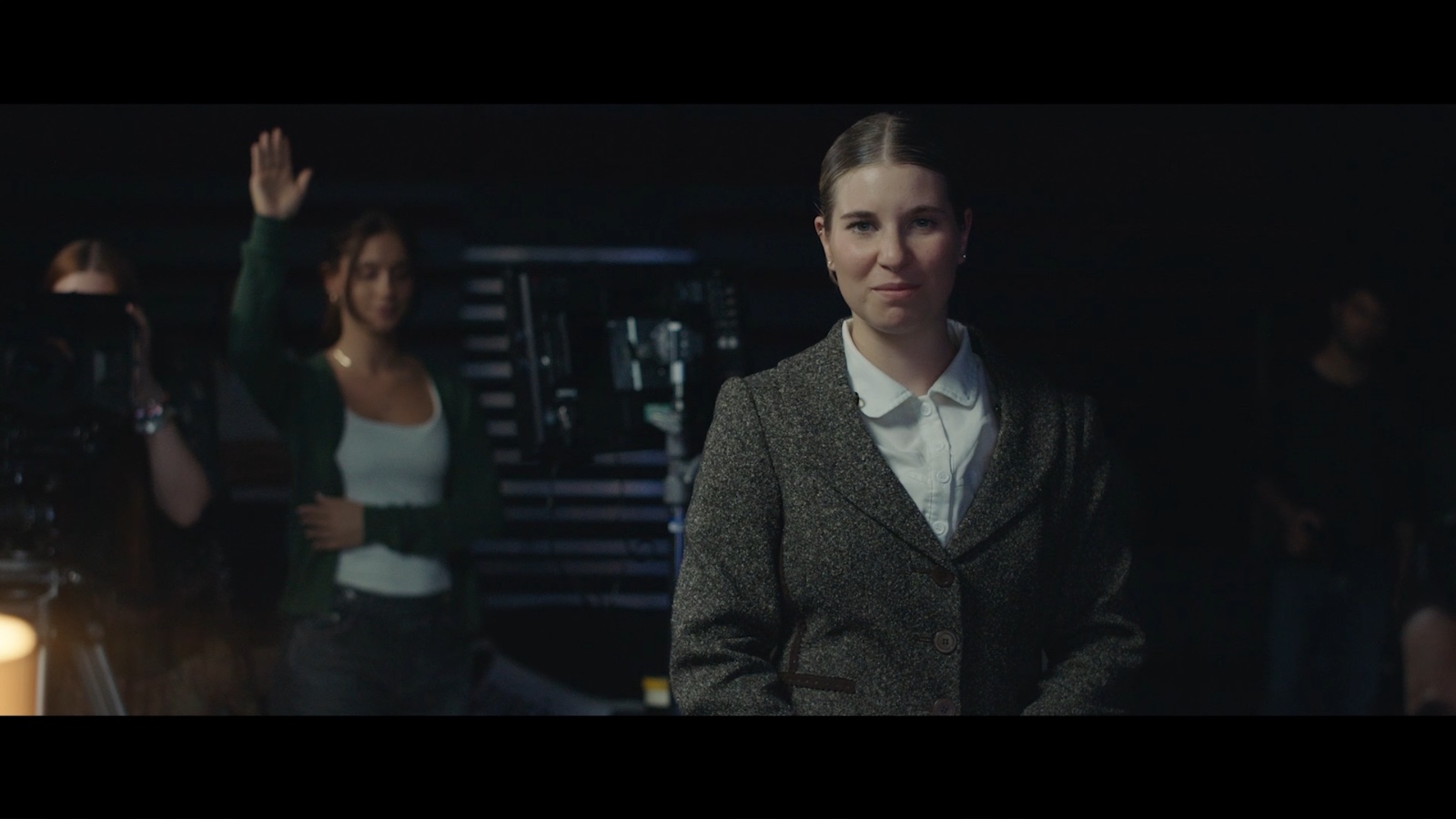 Between Worlds: A woman seated behind a desk