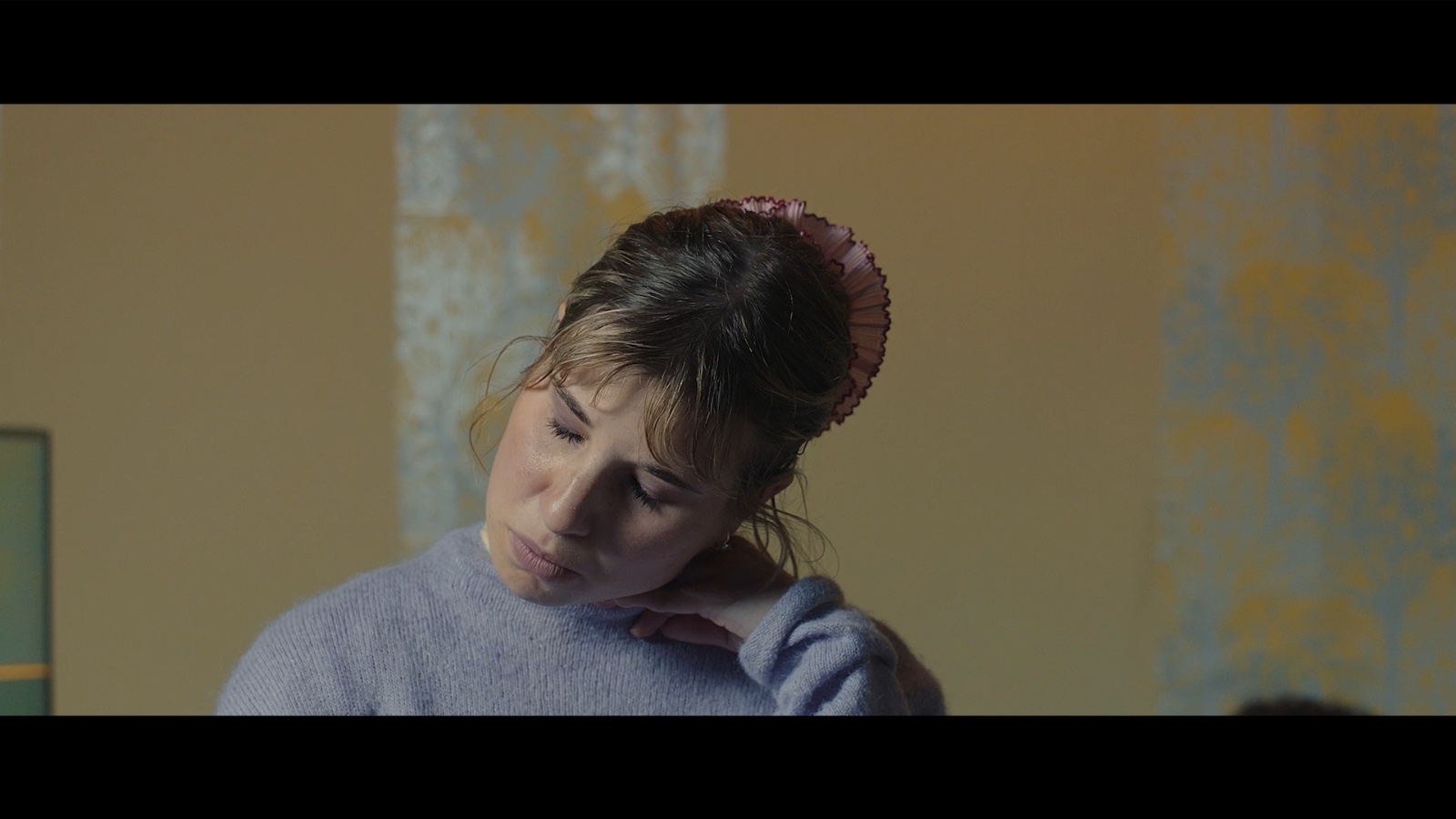 Between Worlds: A woman looking towards the camera