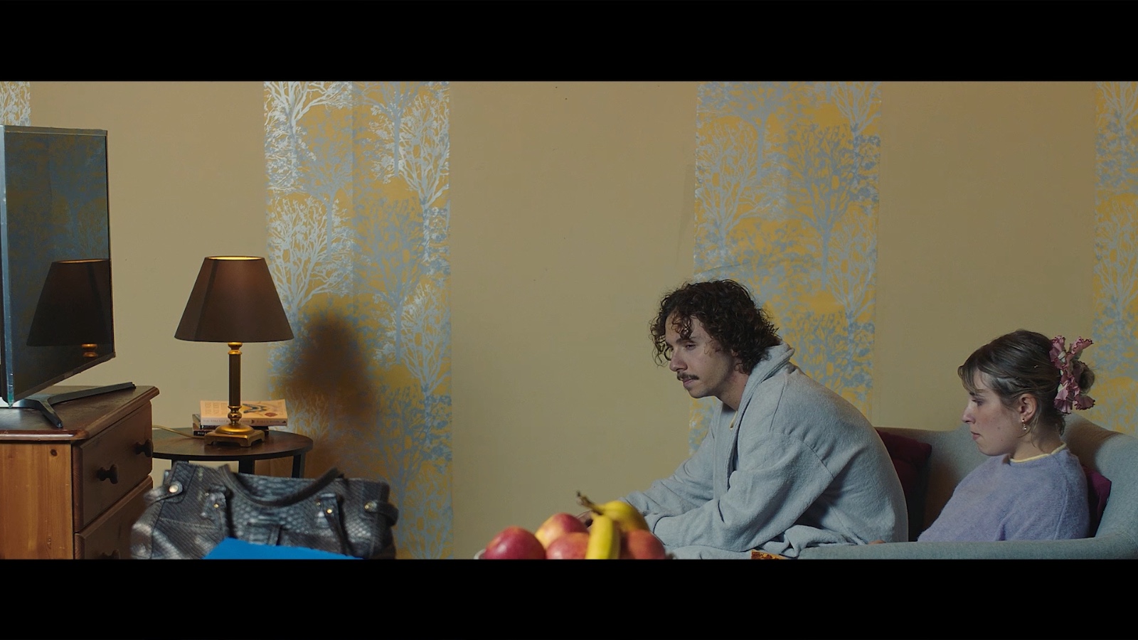Between Worlds: Two people in a living room