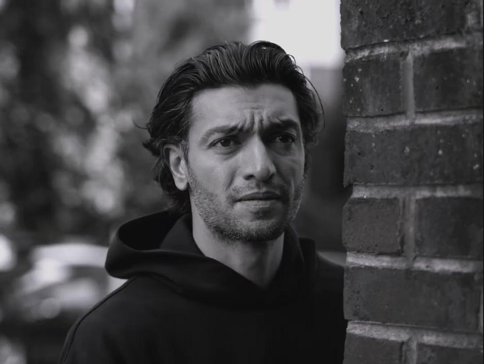 Find My Phone: Close-up of a man beside a brick wall