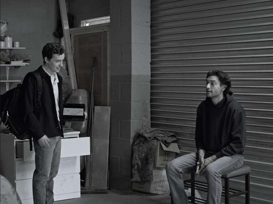 Find My Phone: Two men talking outside a shop