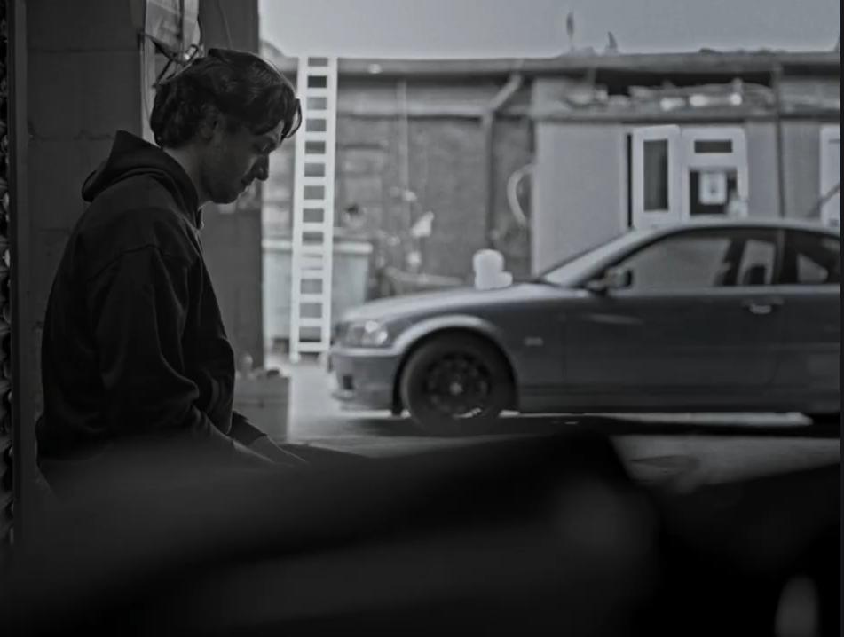 Find My Phone: A man on the pavement beside a parked car