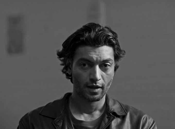 Find My Phone: Portrait of a man in a dark hoodie