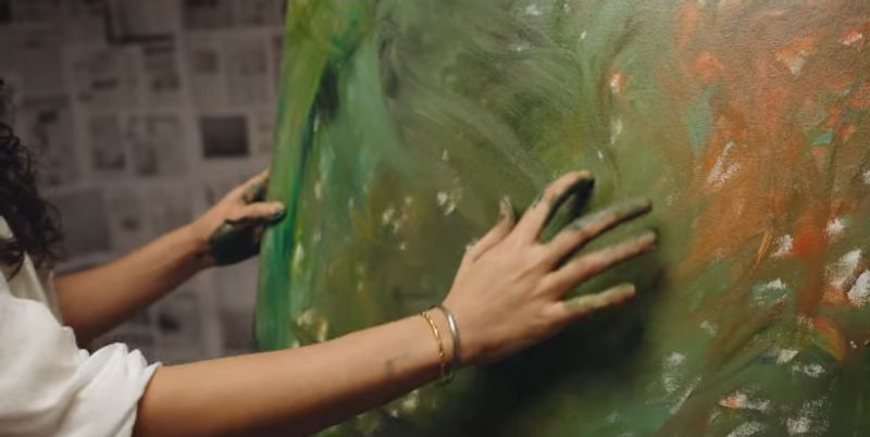 Choke: Paint-covered hands against a canvas