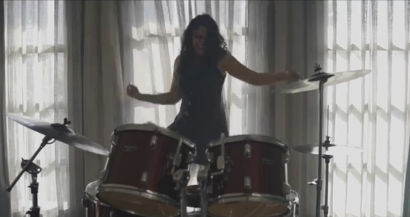 Entrapment: A woman performing at a drum kit